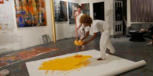 Two woman are painting with yellow color painting